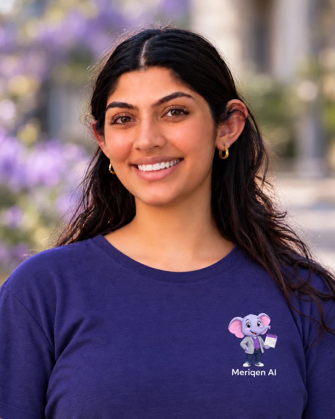 Portrait of Nikita Tejwani, smiling, in a navy Meriqen AI t-shirt.